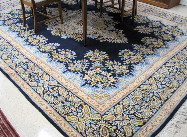 Appraisal: PERSIAN KERMAN CARPET central floral medallion design on plain blue