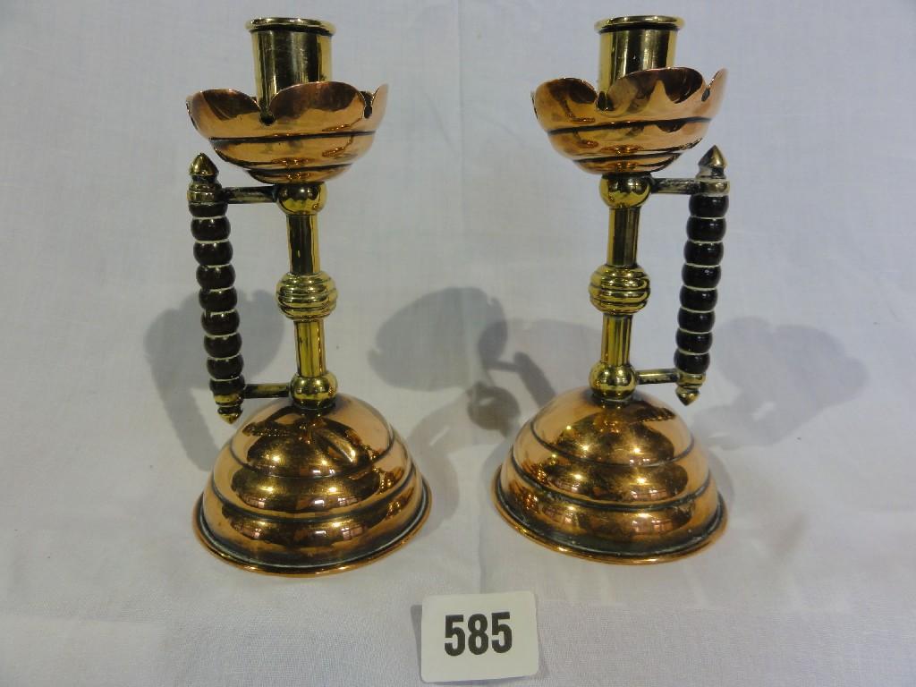 Appraisal: A pair of copper and brass aesthetic style candlesticks with