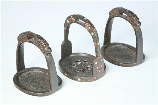 Appraisal: THREE STIRRUPS Asian th century cast iron A pair with