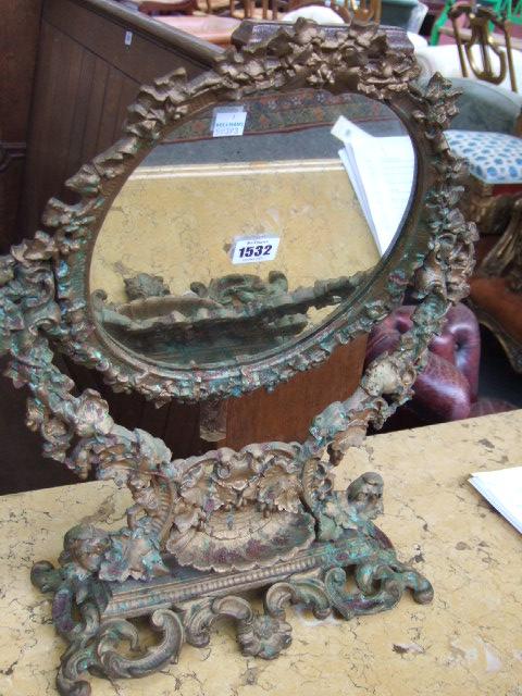 Appraisal: A Victorian cast iron swing frame mirror of oval form