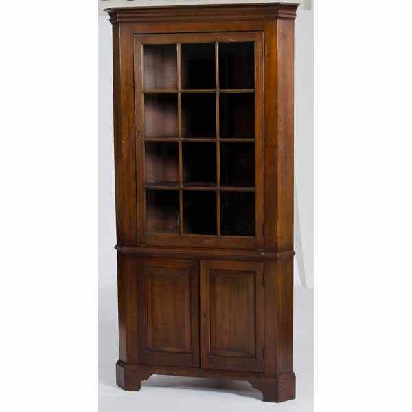 Appraisal: Walnut Corner Cupboard American th century a corner cupboard in