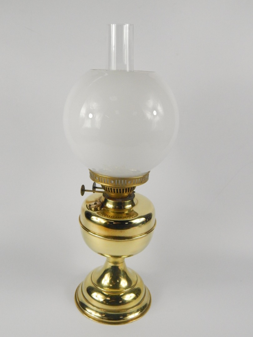 Appraisal: A Duplex brass oil lamp with a circular white glass