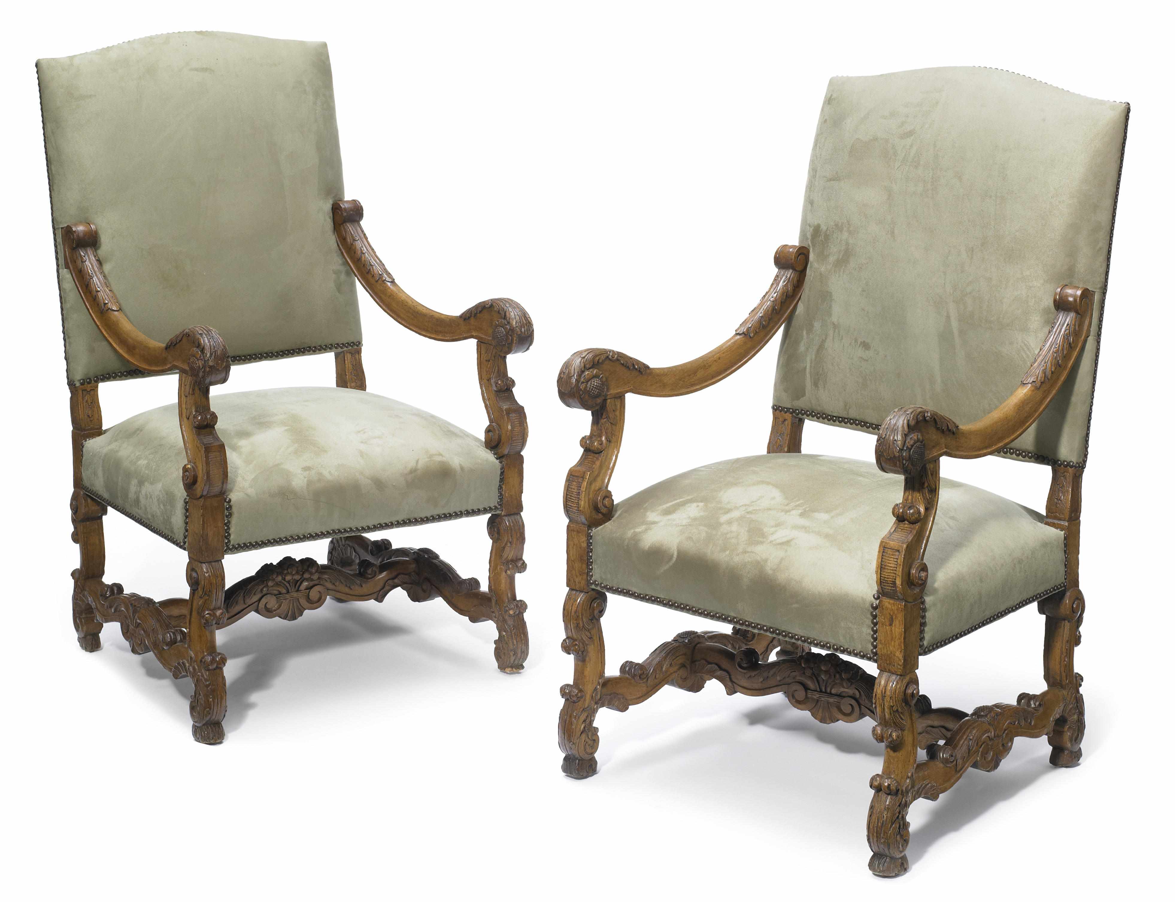 Appraisal: A pair of Louis XIV style carved walnut fauteuils height