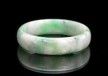 Appraisal: A Burmese Jadeite Wide Bangle Bracelet A demilune carved jadeite