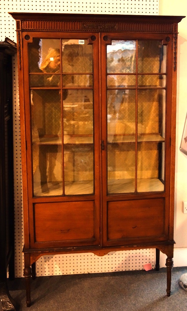 Appraisal: A late th century mahogany glazed two door display cabinet