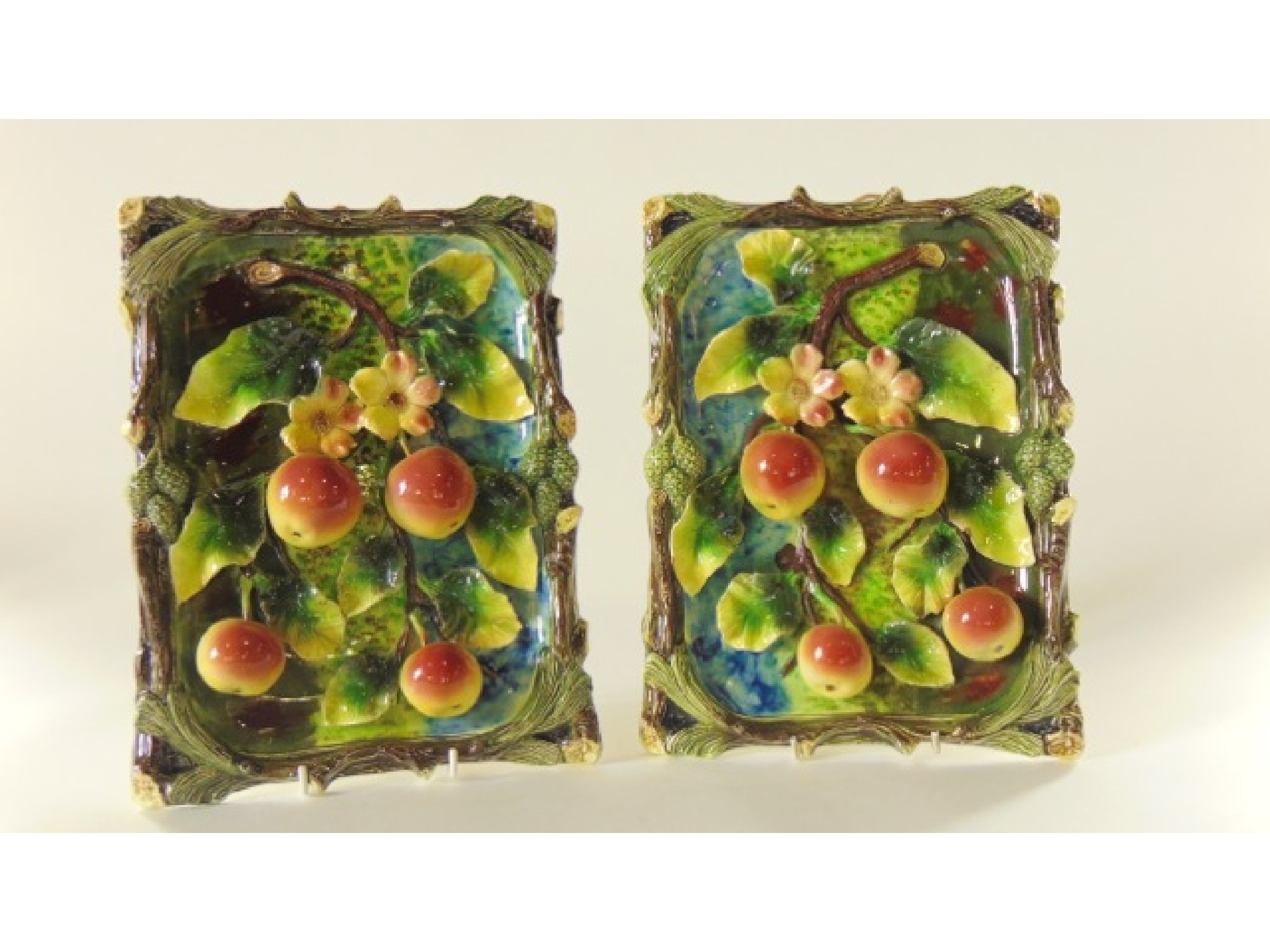 Appraisal: A pair of relief moulded plaques with fruit and blossom