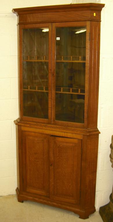 Appraisal: Oak standing corner cabinet with a moulded cornice over two