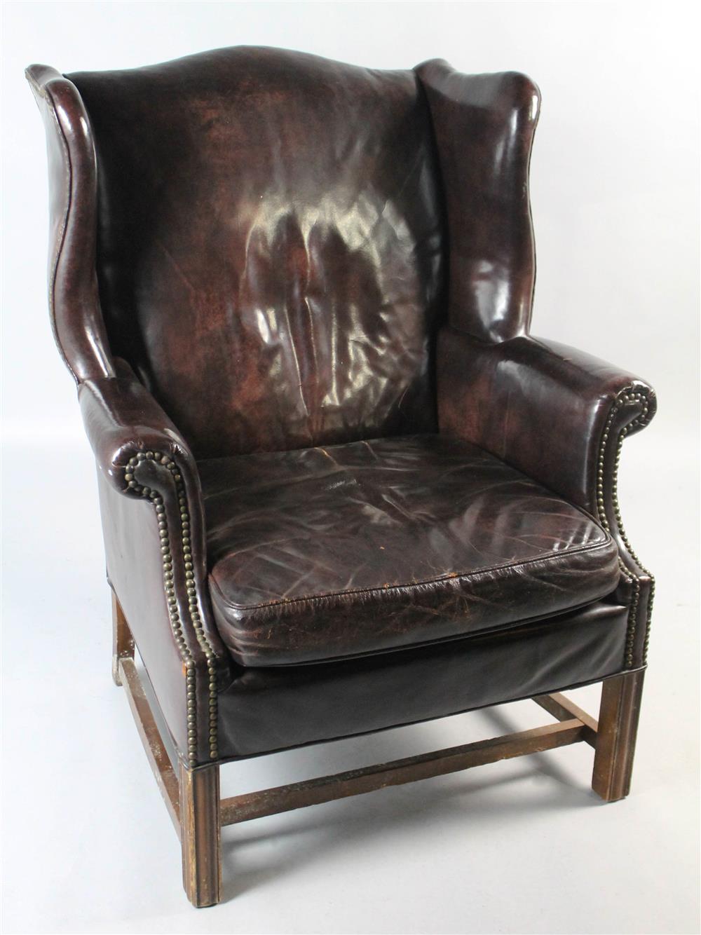 Appraisal: CHIPPENDALE STYLE LEATHER WING CHAIR having an arched crest rail