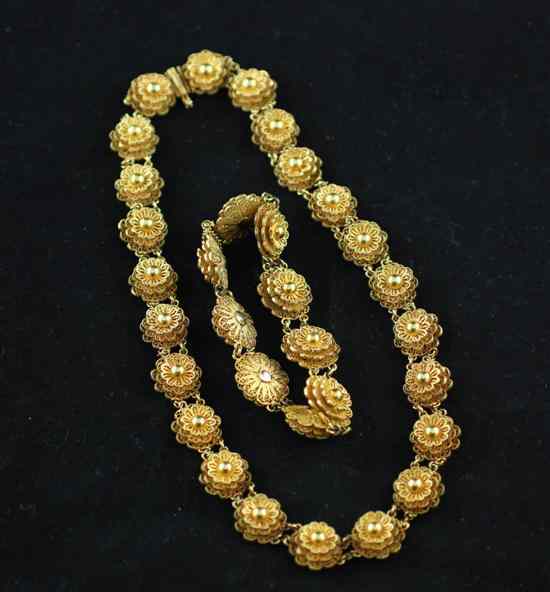 Appraisal: An Indian gold filigree work necklace with triple flowerhead links