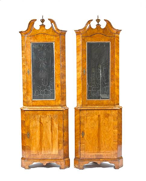 Appraisal: A pair of German Rococo parcel gilt walnut corner cabinets