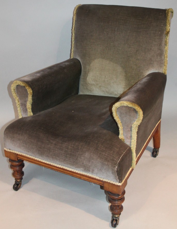 Appraisal: An Edwardian walnut framed armchair with shaped back arms and