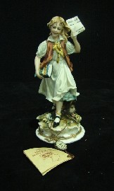 Appraisal: A Capodimonte bisque figure of a school girl with original