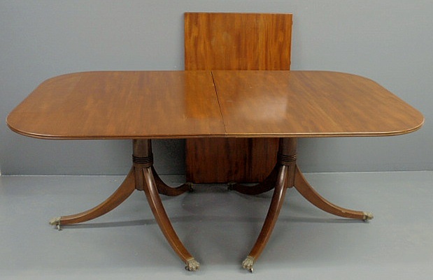 Appraisal: Mahogany banquet table with a double pedestal down-swept legs and