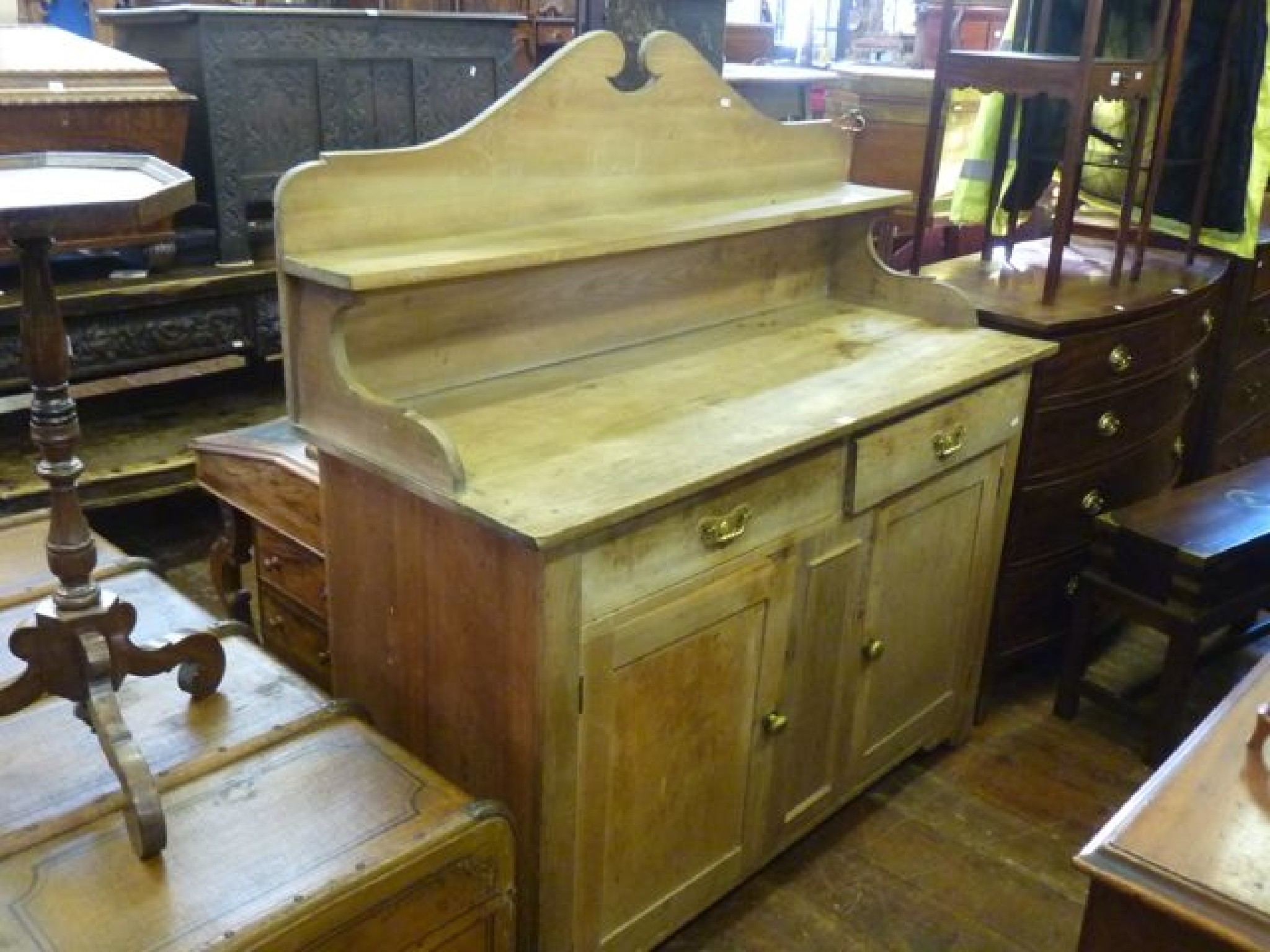 Appraisal: A th century stripped pine sideboard dresser enclosed by two