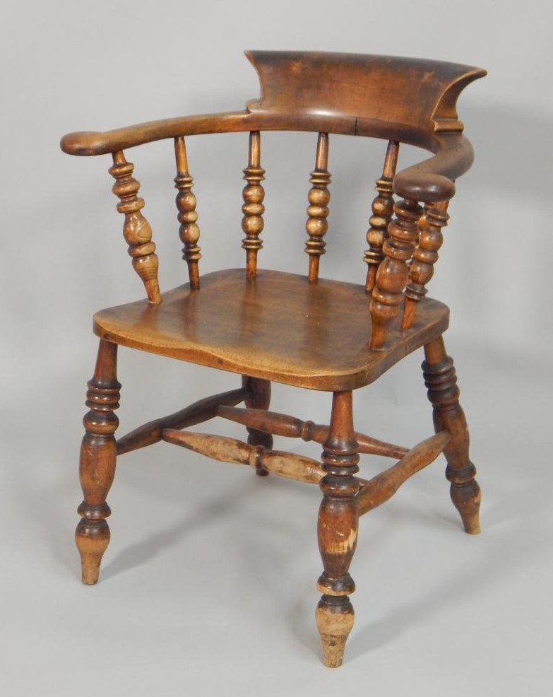 Appraisal: A thC ash and elm captains type chair with spindle