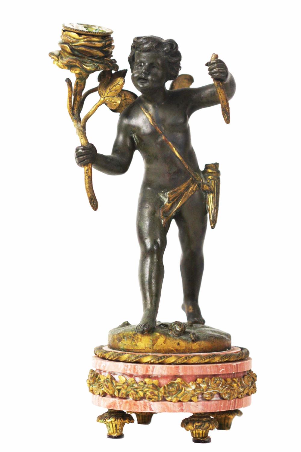 Appraisal: FRENCH BRONZE PUTTI-FORM CANDLESTICK th Century The winged putto holding