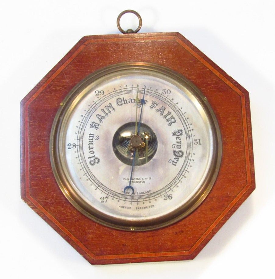 Appraisal: An Edwardian and mahogany boxwood strung aneroid wall barometer by