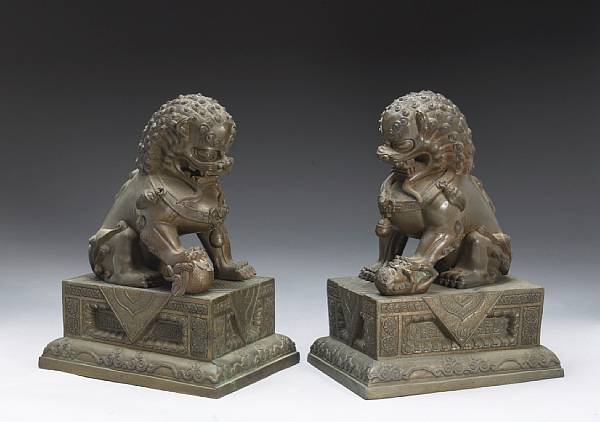 Appraisal: A pair of cast bronze lion dogs and stands One