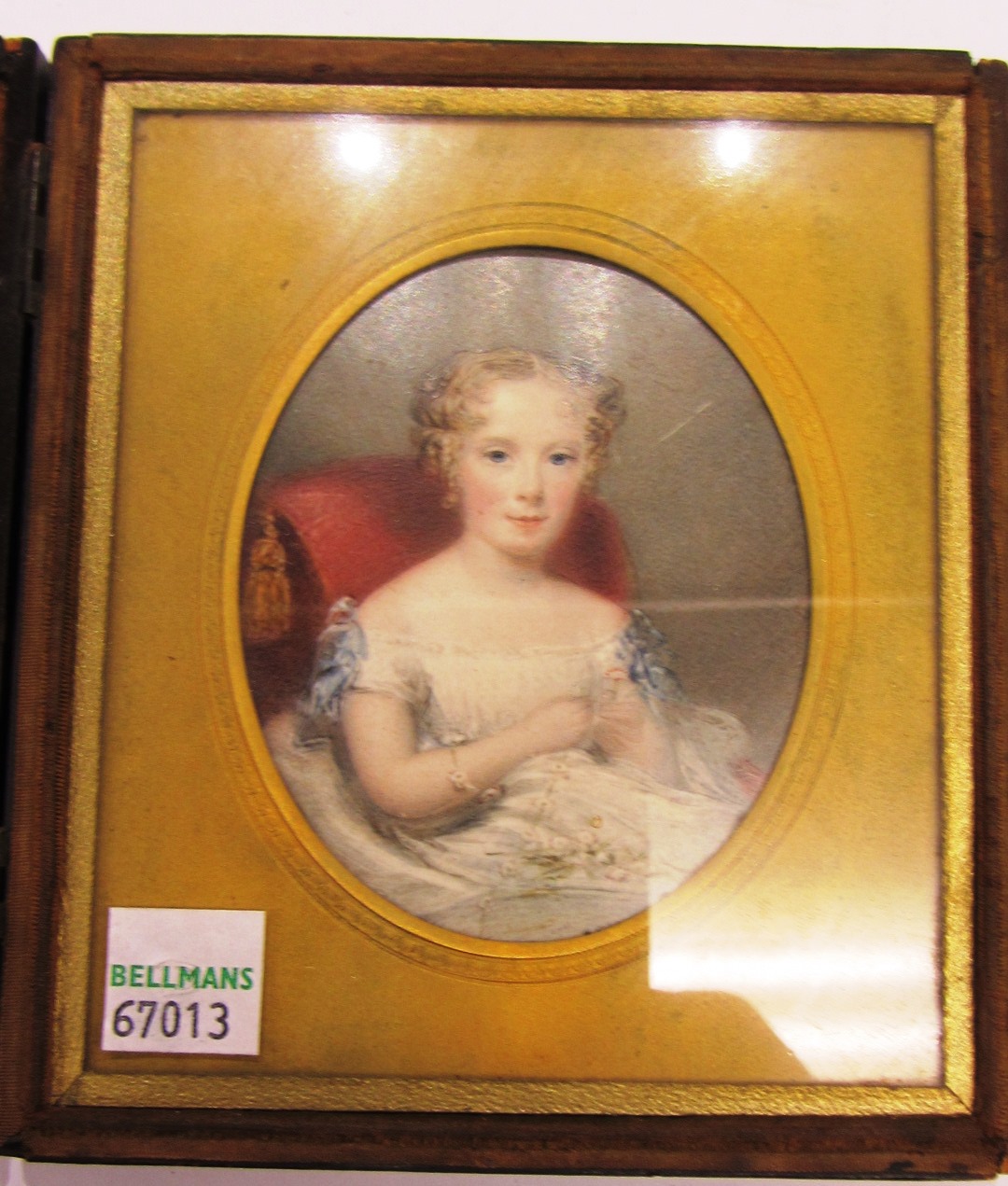 Appraisal: An oval portrait miniature of a young girl with curly