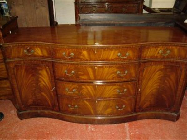 Appraisal: A large mahogany serpentine front sideboard