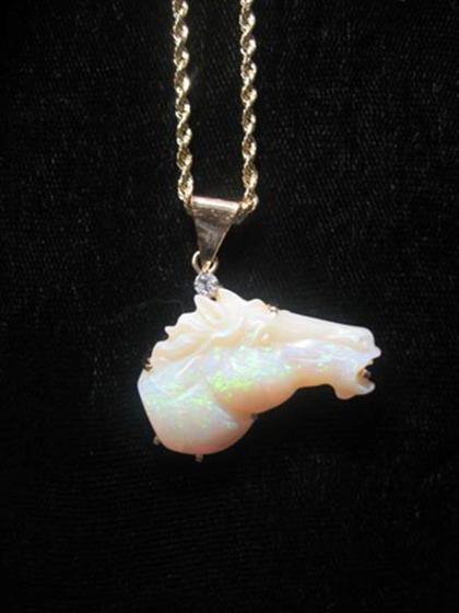 Appraisal: karat yellow gold and opal horse pendant Carved white opal