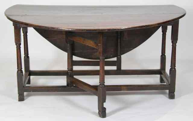 Appraisal: An oak gateleg table circa with oval two-flap top on