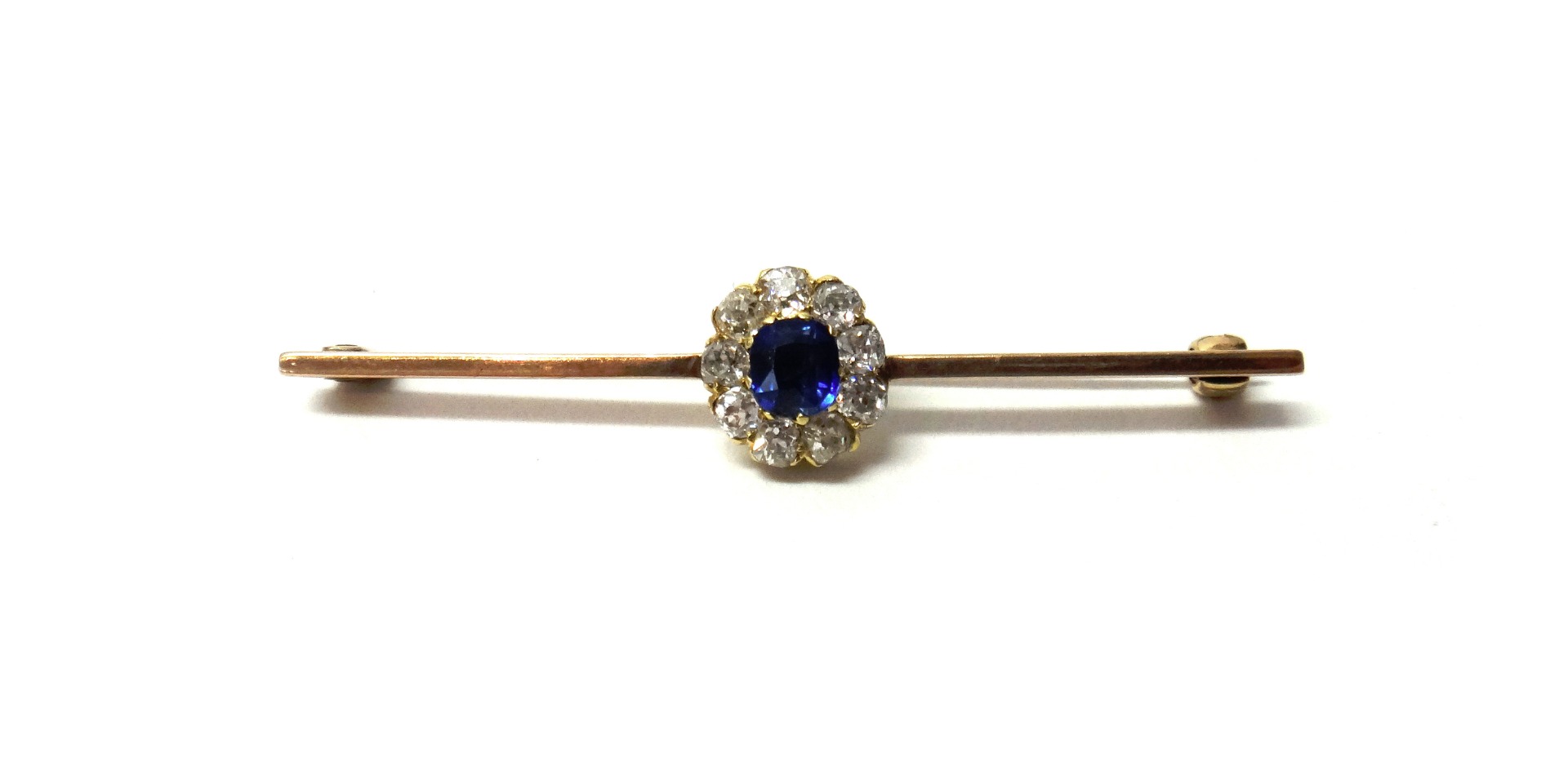 Appraisal: A gold sapphire and diamond set cluster bar brooch claw