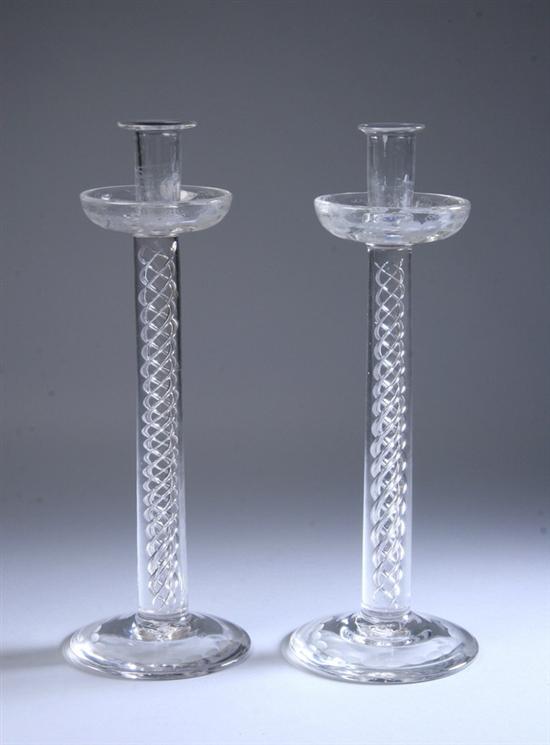 Appraisal: PAIR HANDBLOWN CLEAR GLASS CANDLESTICKS Circular foot ribbon-twist shaft drip