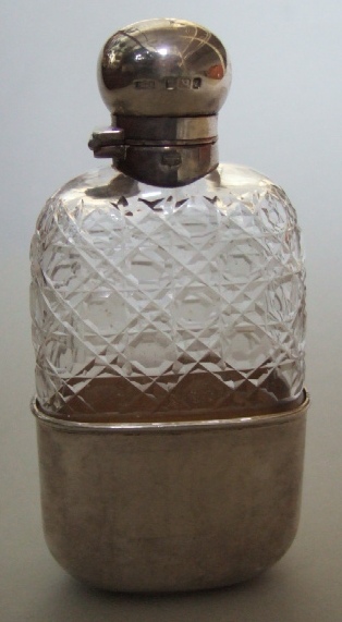 Appraisal: A silver mounted faceted glass rectangular spirit flasks with a