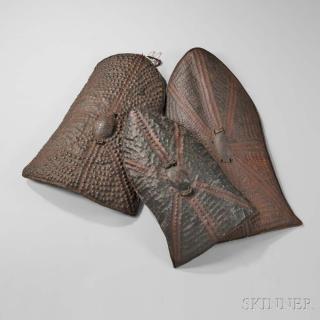 Appraisal: Three African Embossed Hide Shields probably made by the Wandala