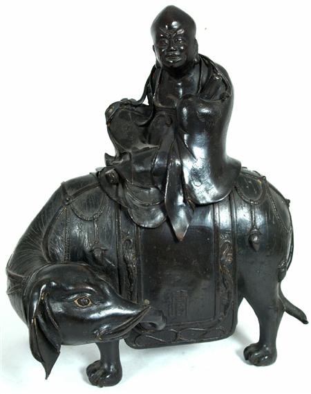 Appraisal: A Chinese bronze figure of an Immortal riding an elephant