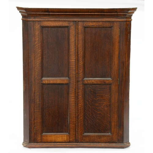 Appraisal: An oak hanging corner cupboard with pair of twin-panel doors