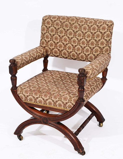 Appraisal: A LATE VICTORIAN WALNUT FRAMED ARMCHAIR with inverted hoop and