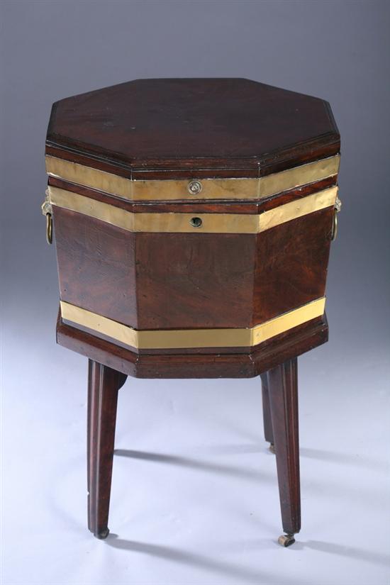 Appraisal: GEORGIAN BRASS-MOUNTED WALNUT CELLARETTE early th century Hinged molded-edge octagonal