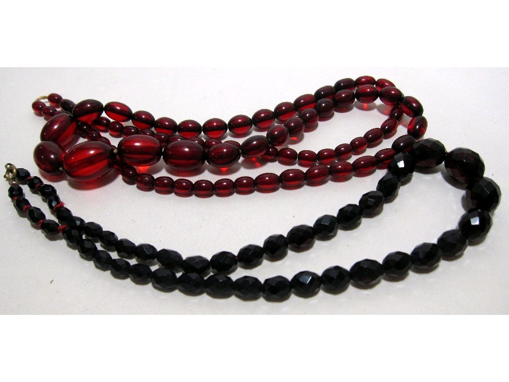 Appraisal: Two strings of red amber beads