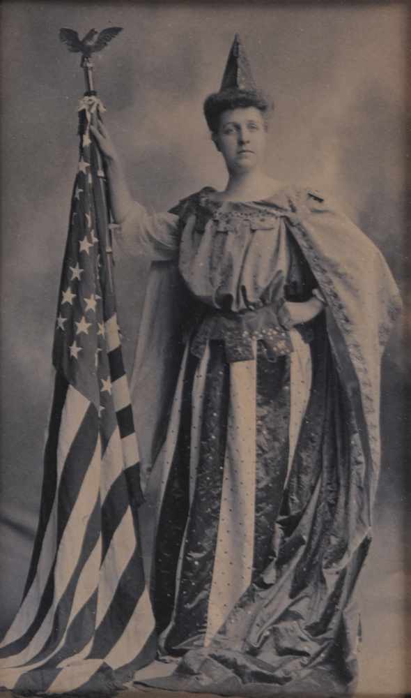 Appraisal: MARION C SUFFRAGETTE IN FLAG COSTUME Toned bromide print Provenance