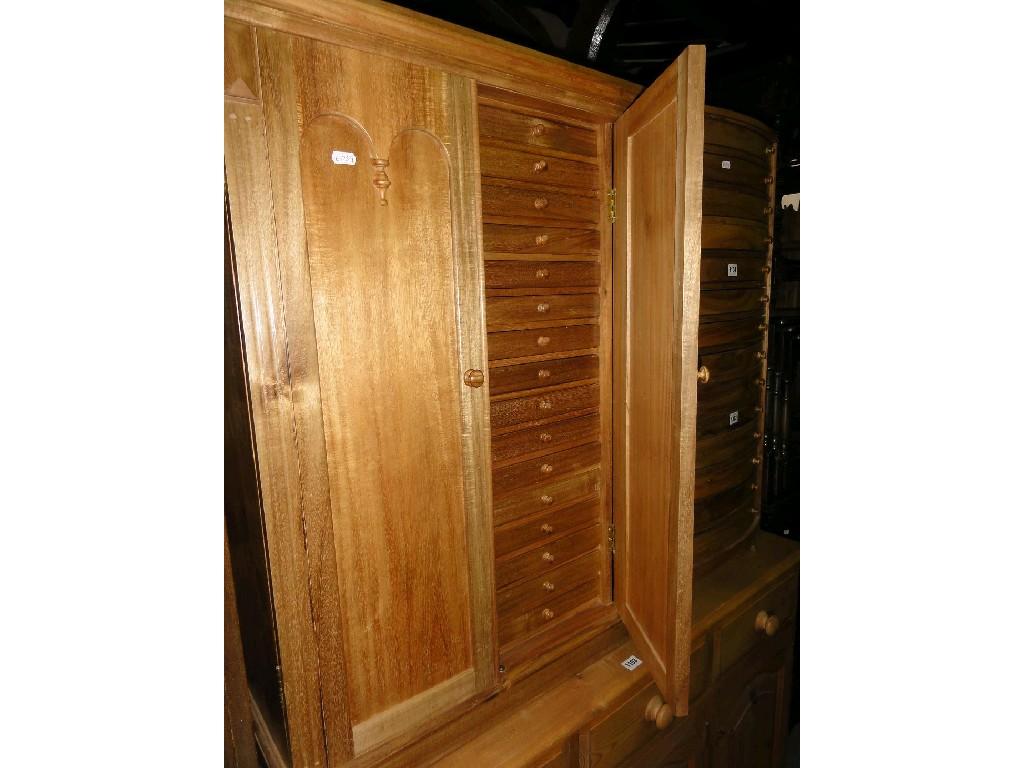 Appraisal: A hardwood specimen cabinet enclosed by a pair of double