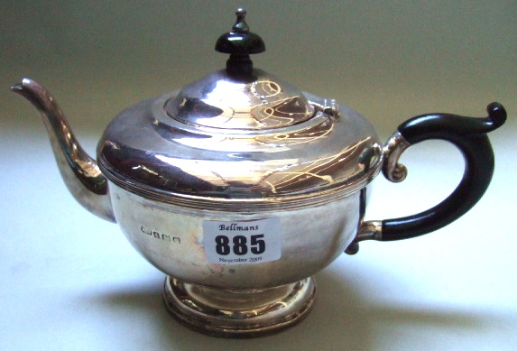 Appraisal: A silver teapot of circular form with black fittings Birmingham