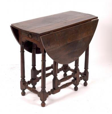 Appraisal: An oak two-flap oval gateleg table fitted a drawer on