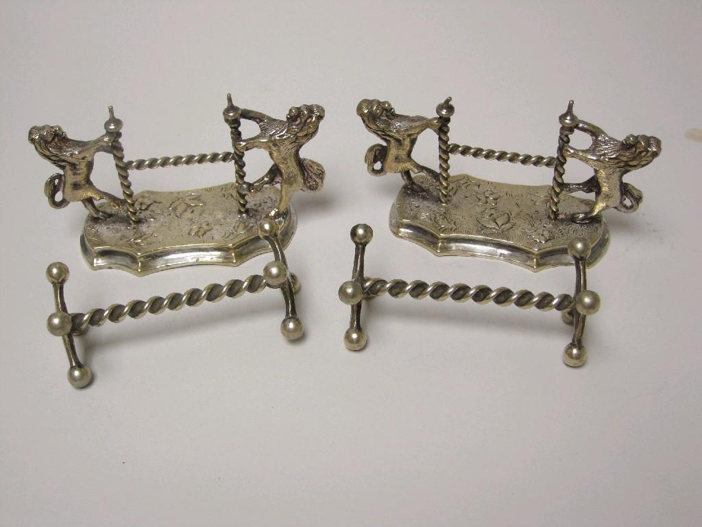 Appraisal: Pair of plated lion rampant Knife Rests and another pair