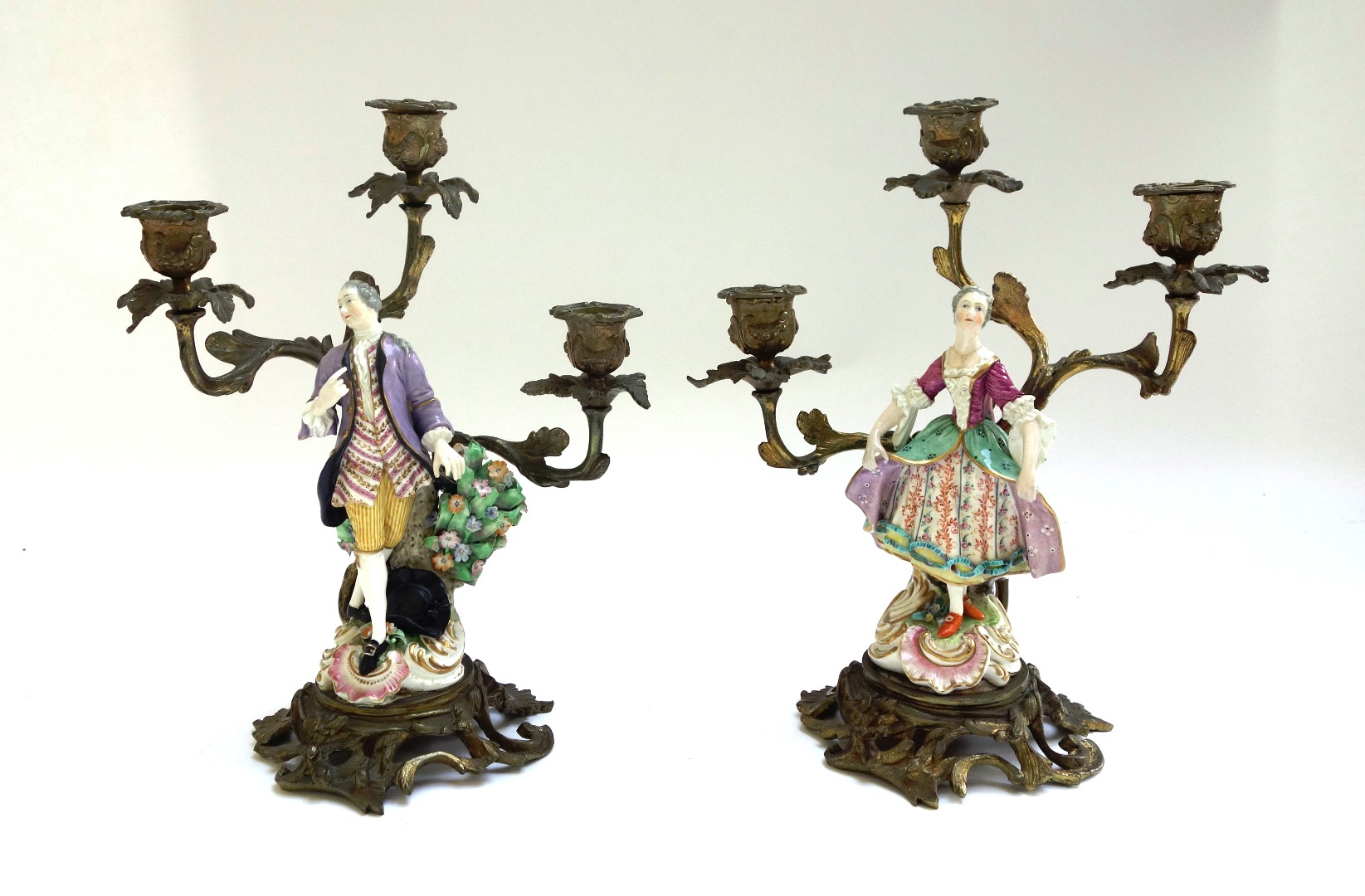 Appraisal: A pair of bronze and porcelain mounted figural three branch