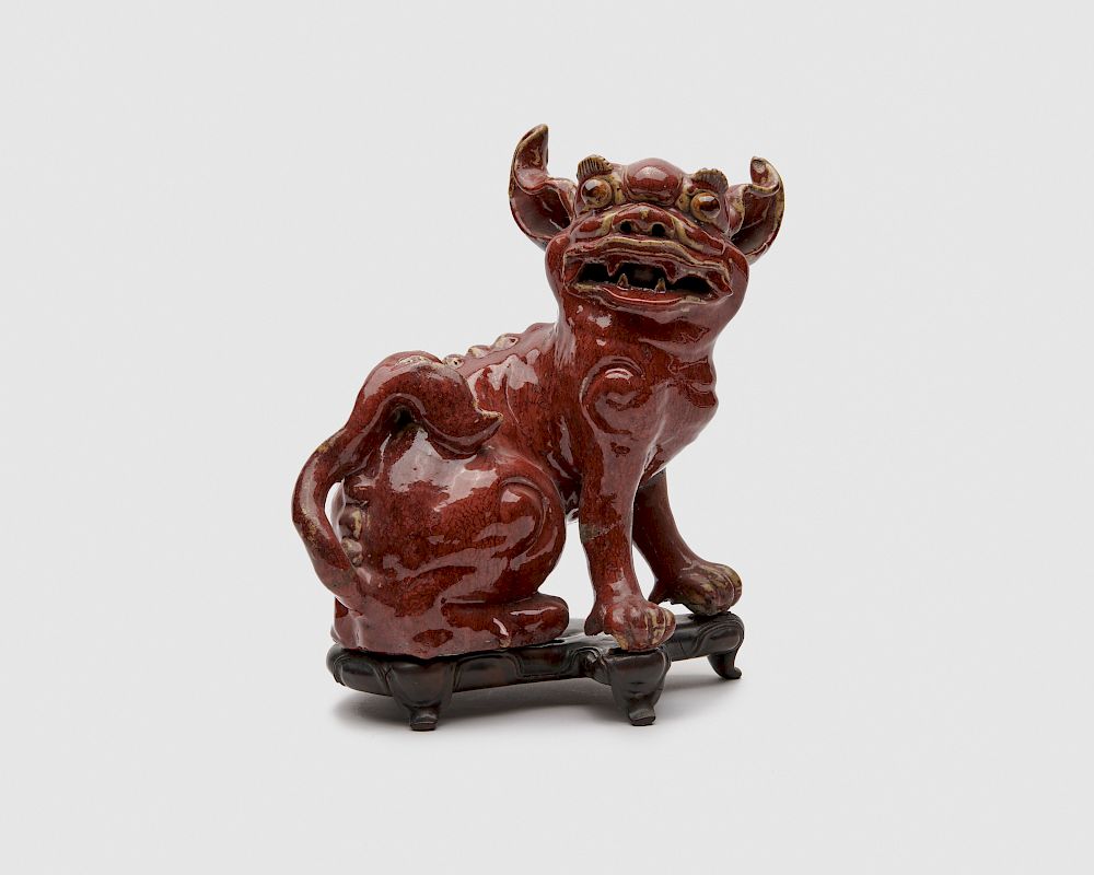 Appraisal: Chinese Oxblood Glazed Earthenware Figure of a Foo Lion on