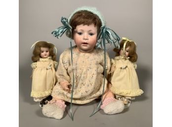 Appraisal: Three antique bisque head dolls including a pair of unmarked