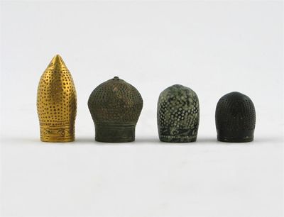 Appraisal: Four South East Asian metal caps perhaps thimbles one gold