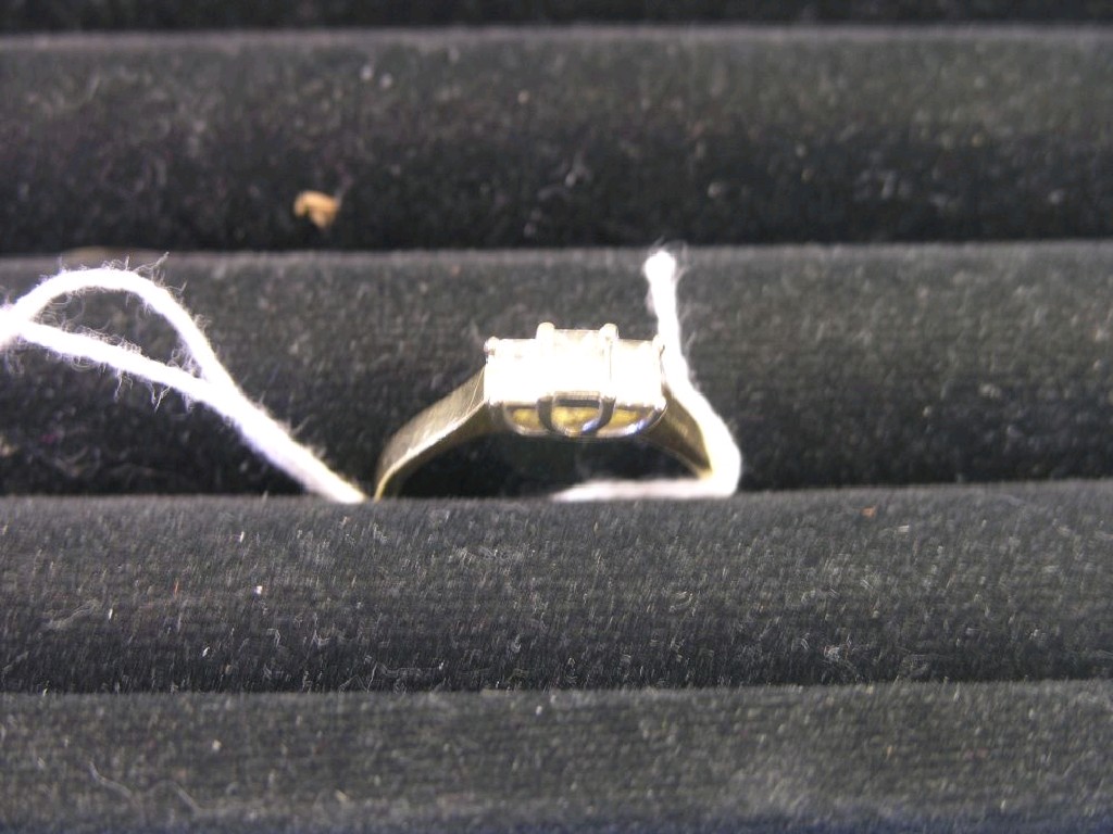 Appraisal: An ct three stone diamond ring baguette diamonds within claw