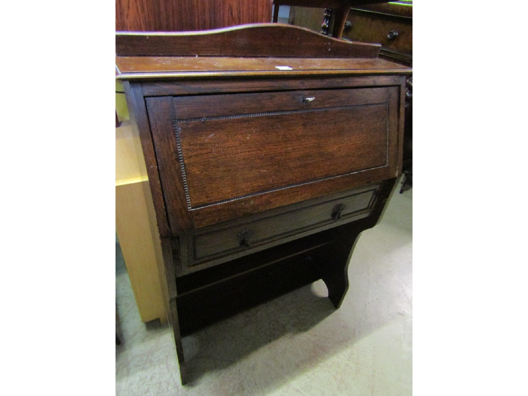 Appraisal: A s slim oak bureau the fall flap enclosing a