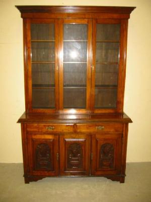 Appraisal: A VICTORIAN WALNUT TWO STAGE BOOKCASE the moulded cornice over