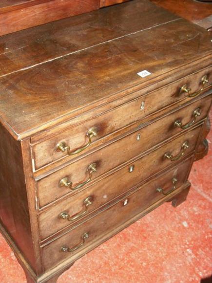 Appraisal: A George III mahogany chest of drawers with brushing slide