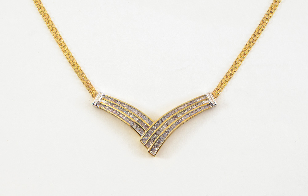 Appraisal: DIAMOND CHEVRON NECKLACE K yellow gold necklace with round single