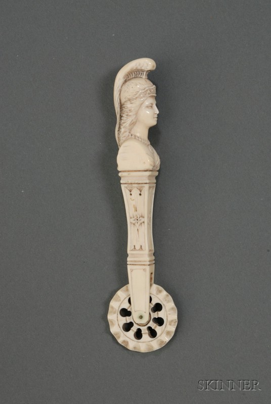 Appraisal: Carved Ivory Jagging Wheel th century the handle topped with